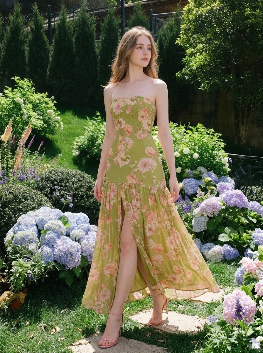 Woman wearing a green floral print strapless maxi dress standing in a garden