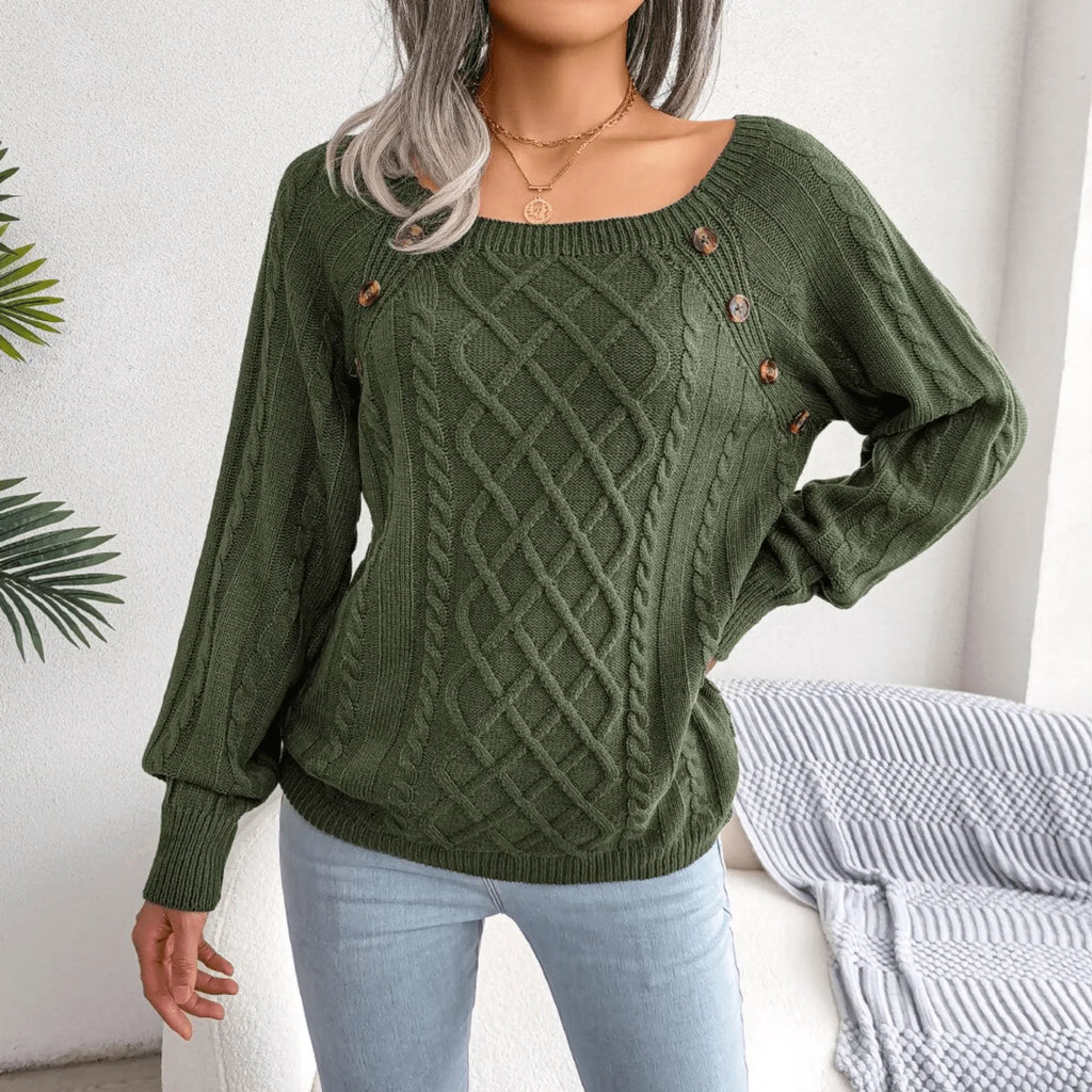 Close-up of the front of a green cable knit sweater with decorative buttons