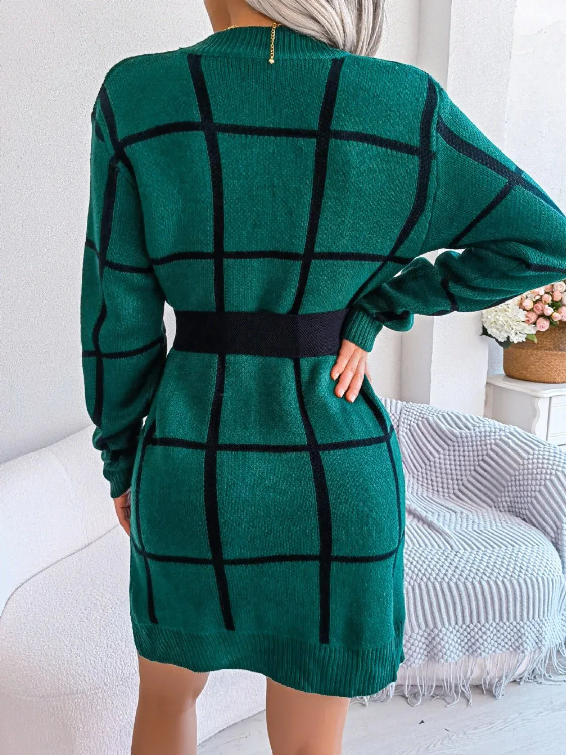 back view of a woman in a green plaid knit dress
