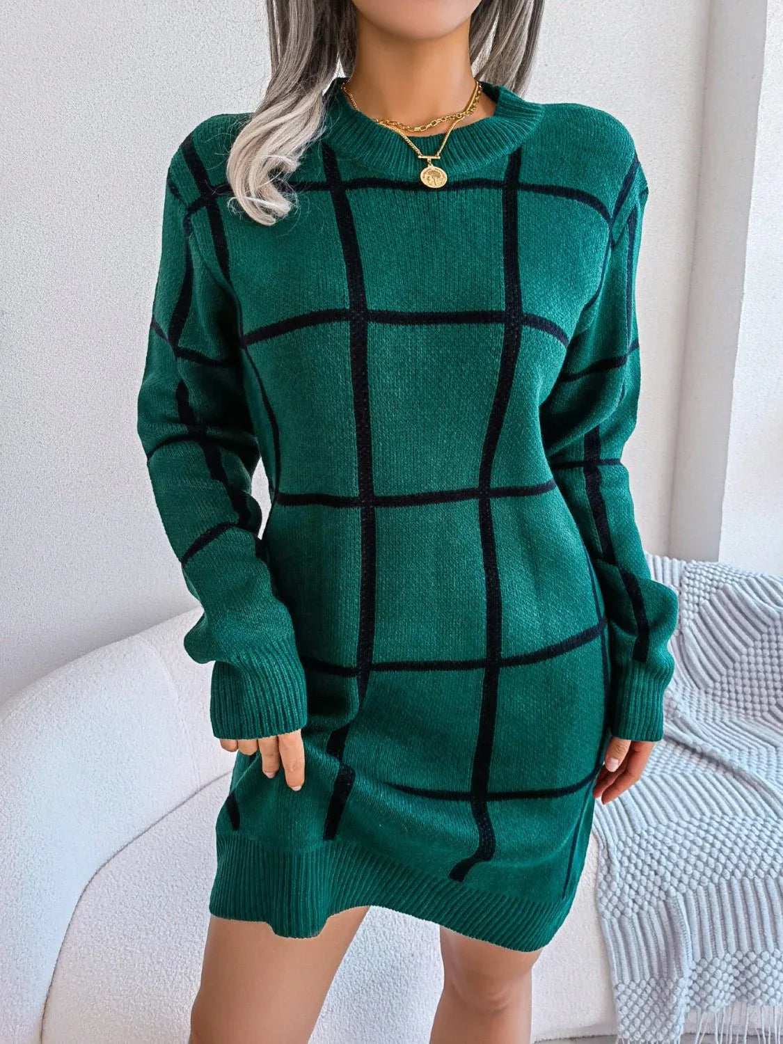 front view of a woman in a green plaid knit dress