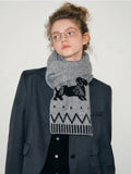 Model showcasing a grey knit scarf with a playful dachshund design