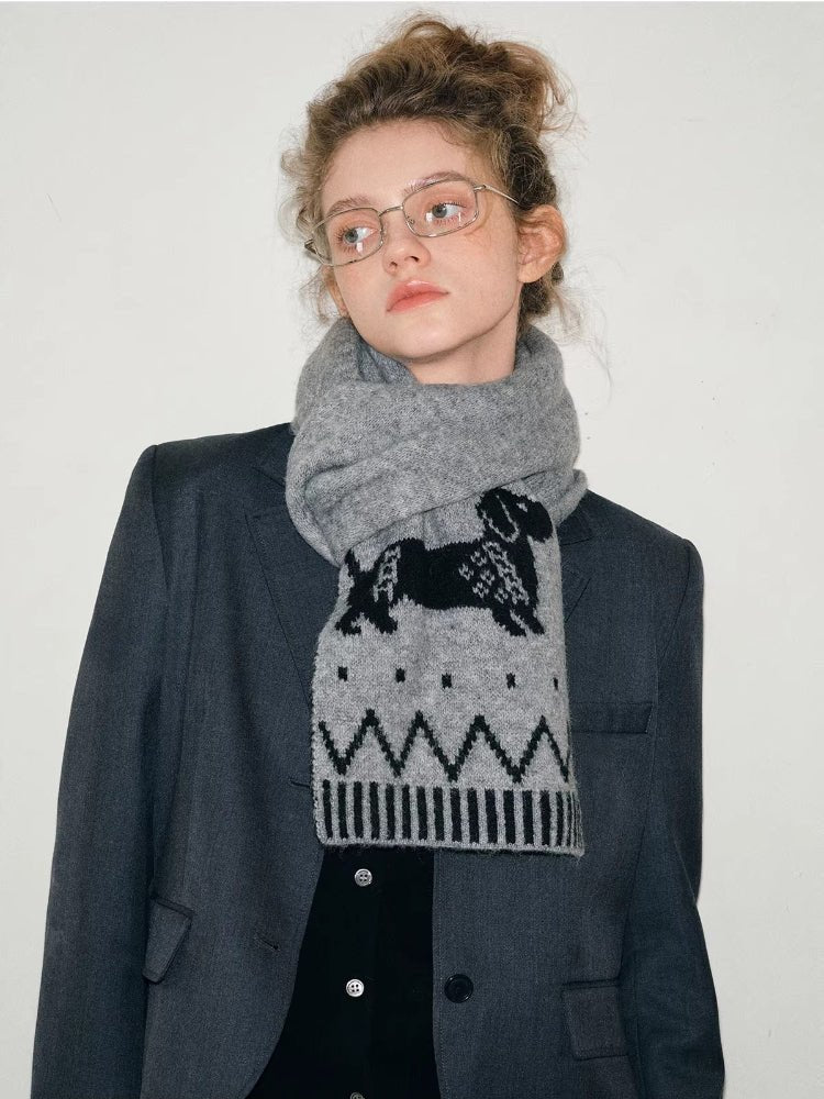 Model showcasing a grey knit scarf with a playful dachshund design