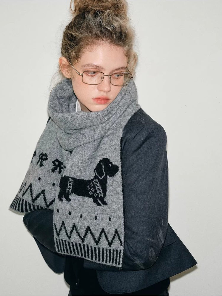 Close-up of a grey knit scarf featuring a dachshund illustration