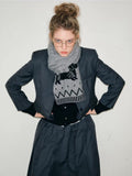 Woman posing with a grey scarf adorned with a dachshund motif and zig-zag pattern