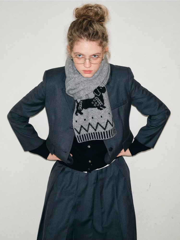 Woman posing with a grey scarf adorned with a dachshund motif and zig-zag pattern