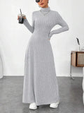 woman wearing a grey ribbed knit maxi dress with a turtleneck and long sleeves