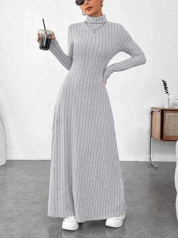 woman wearing a grey ribbed knit maxi dress with a turtleneck and long sleeves