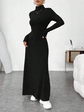 woman wearing a black ribbed knit maxi dress with a turtleneck and long sleeves