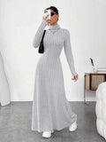 woman taking a mirror selfie in a grey ribbed knit maxi dress