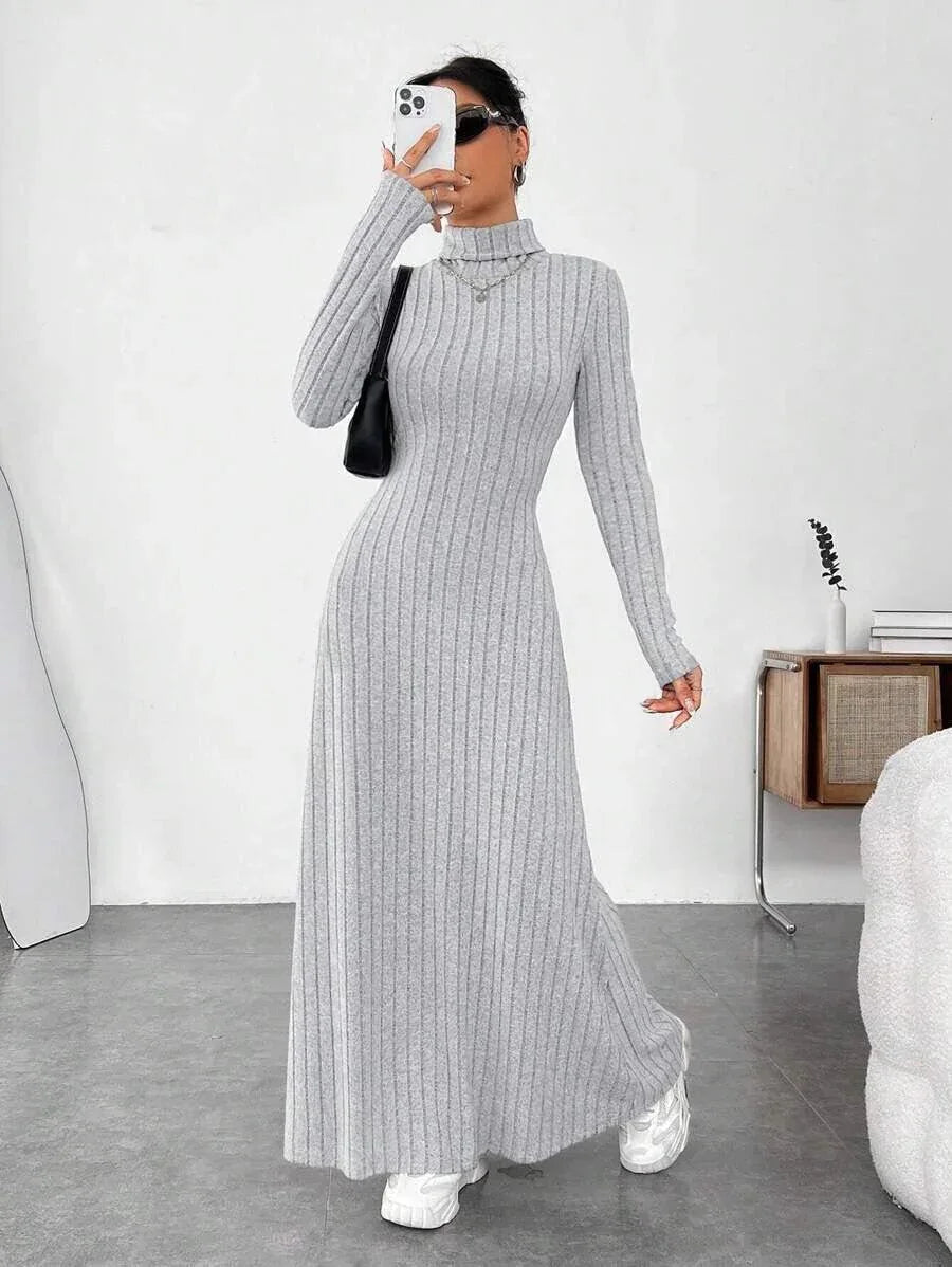 woman taking a mirror selfie in a grey ribbed knit maxi dress