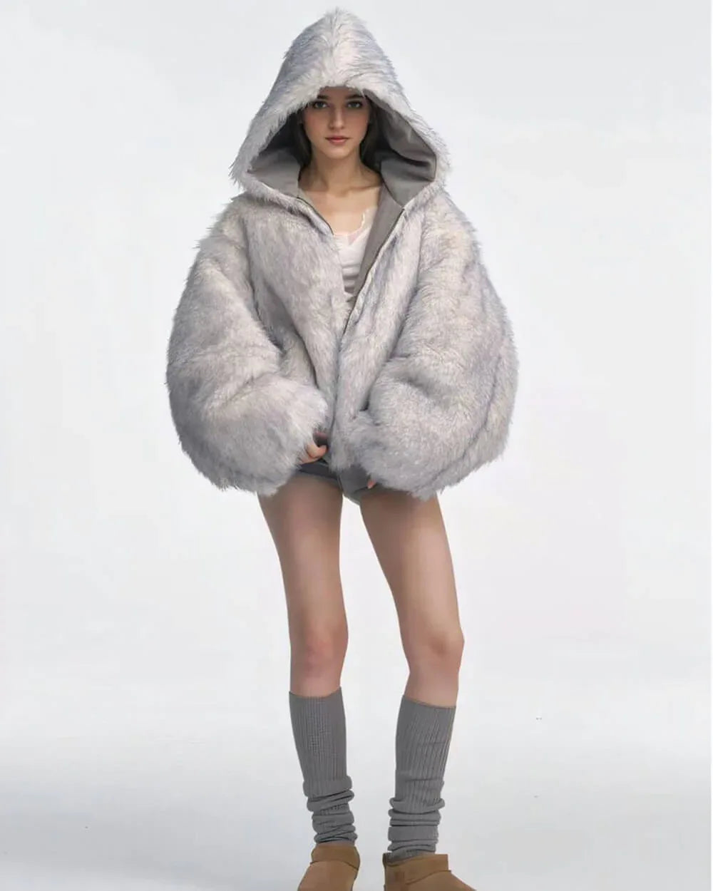 Woman wearing a grey bomber jacket with a large faux fur hood