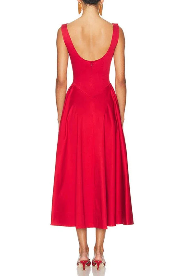 Back view of a woman in a sleeveless red midi dress with a scoop back.