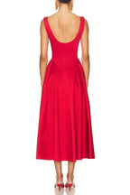 Back view of a woman in a sleeveless red midi dress with a scoop back.