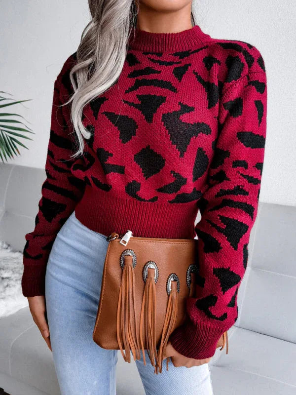 Front view of a woman wearing a red and black leopard print mock neck sweater.