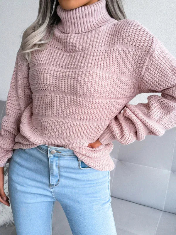 Front view of a woman in a pink knit turtleneck sweater and jeans