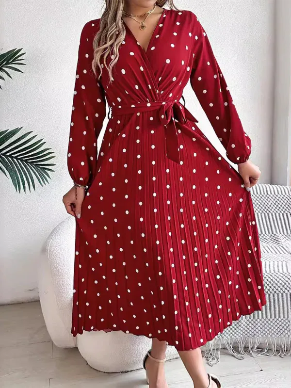 Full body shot of a woman wearing a red polka dot midi dress