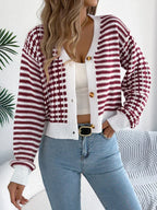 Woman wearing a red and white striped and checkered knit cropped cardigan with a v-neck and button front