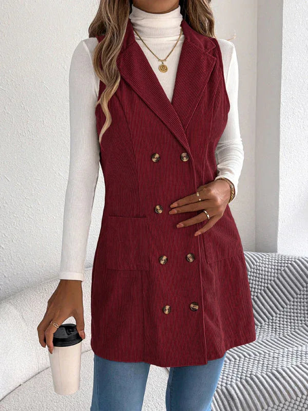 Close-up of a woman wearing a burgundy corduroy vest, showing the double-breasted buttons and lapel.