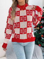 Woman wearing a red and white checkered knit sweater with snowflake print and crew neckline