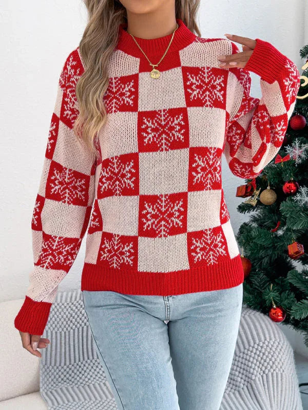 Woman wearing a red and white checkered knit sweater with snowflake print and crew neckline
