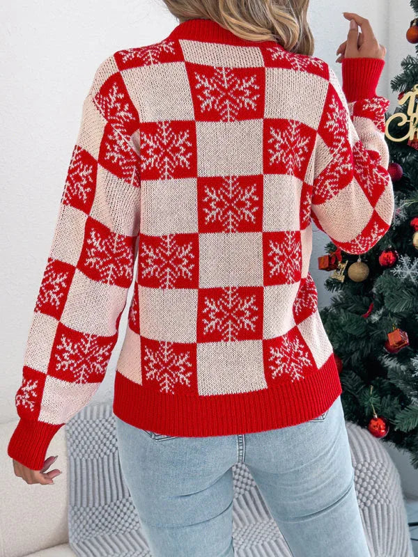 Back view of a woman wearing a red and white checkered knit sweater with snowflake print