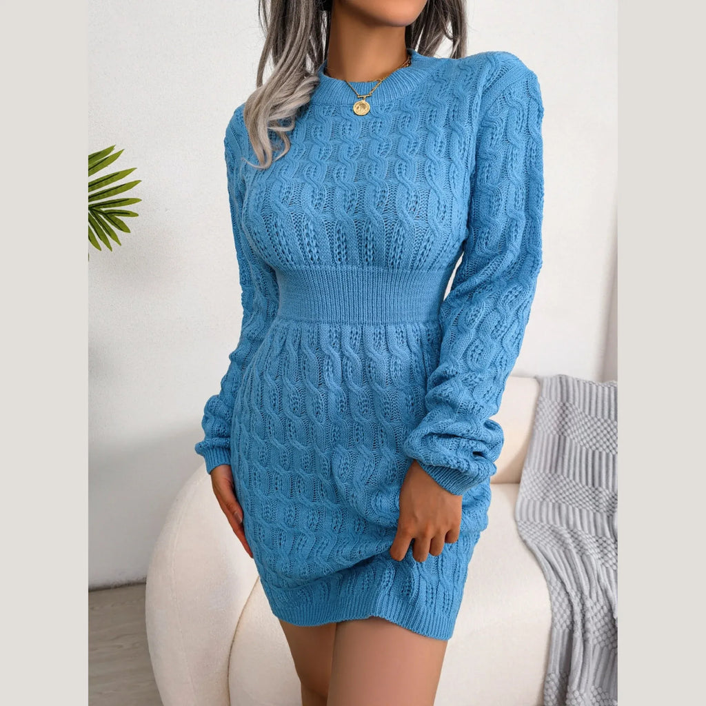 Front view of a woman in a blue cable knit mini dress with long sleeves.