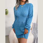 Front view of a woman in a blue cable knit mini dress with long sleeves.