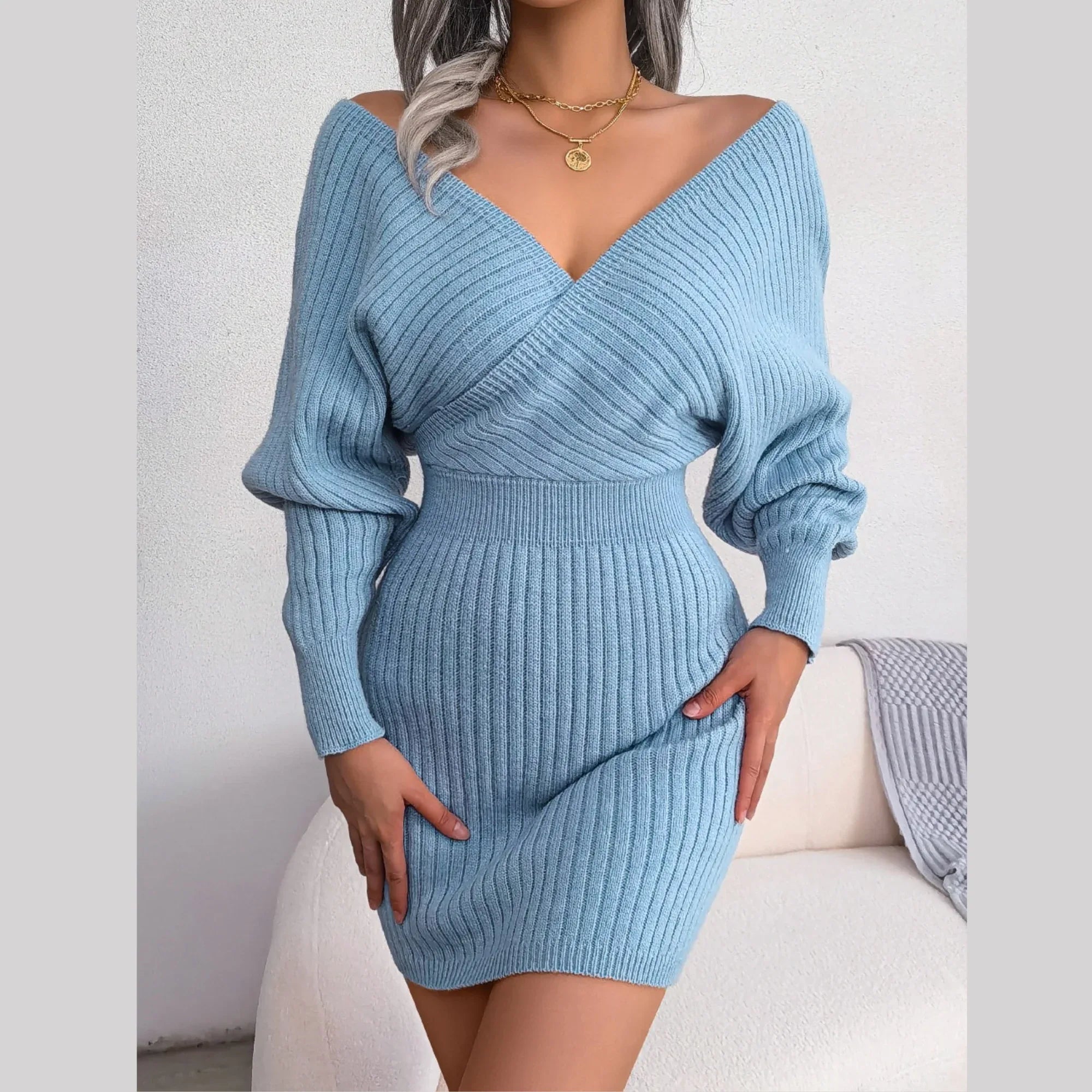 Woman wearing a blue ribbed knit V-neck wrap dress
