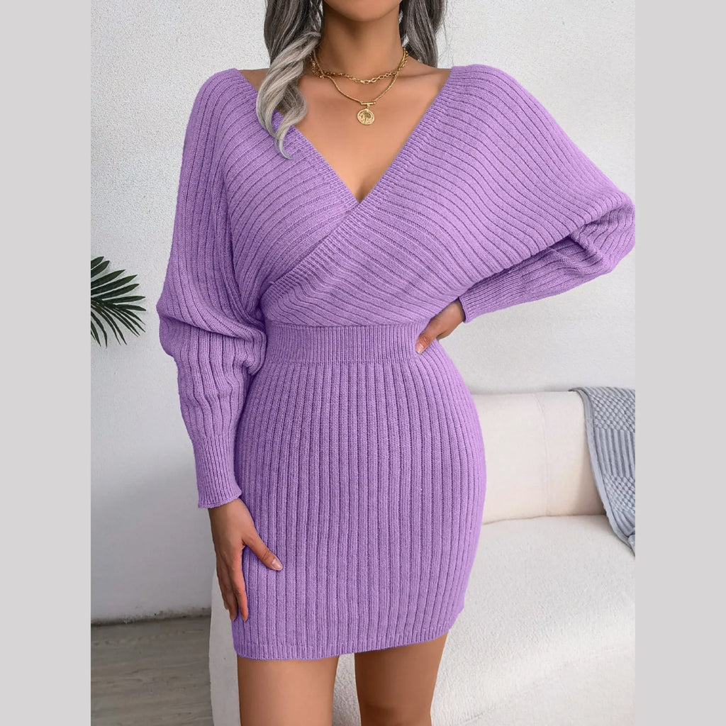 Side profile of a woman in a purple batwing sleeve knit dress
