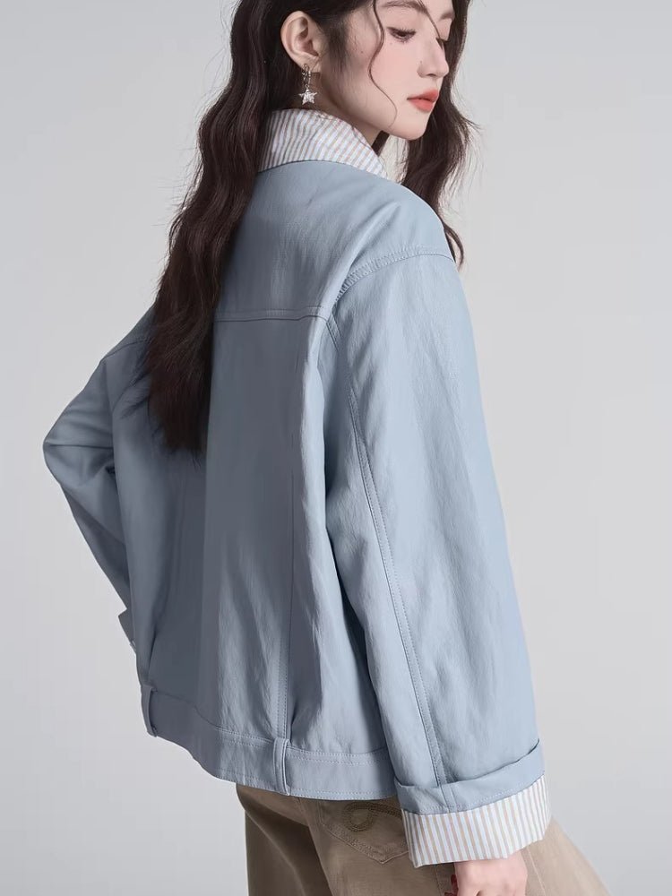 Back view of the light blue bomber jacket with striped cuffs visible
