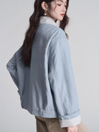 Back view of the light blue bomber jacket with striped cuffs visible
