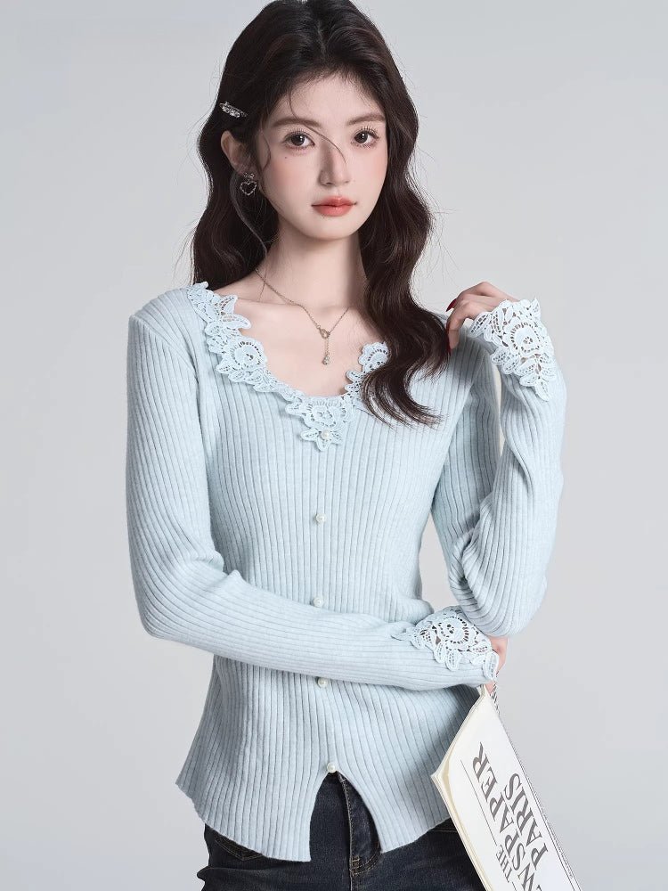 Woman wearing a light blue ribbed knit cardigan with lace trim neckline and cuffs