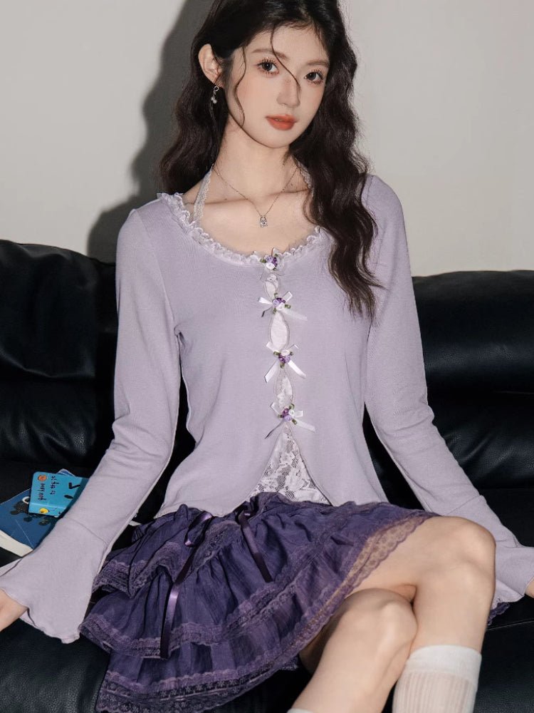 Woman wearing a light purple long-sleeve knit top with ribbon ties and a purple tiered lace skirt