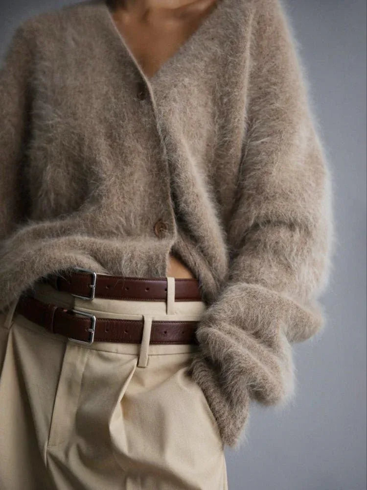 Model wearing a beige fuzzy knit cardigan and beige trousers with a brown belt.