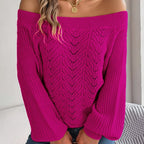 Woman wearing a magenta off-the-shoulder knit sweater with a detailed open-knit pattern on the front and long bishop sleeves.