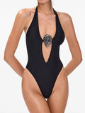 Black one-piece swimsuit with halter neckline and silver decorative accent.
