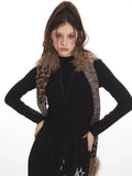 Fashion model in a black long-sleeve top and black maxi skirt with star graphics, styled with a patterned scarf
