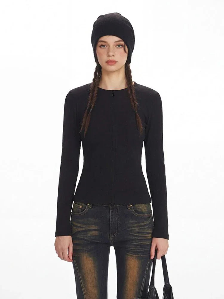 Close-up of the black knit top's zipper detail.