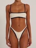 Front view of a cream bikini with black trim and thin straps