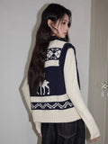 Back view of a woman wearing a navy and cream knit zip-up vest with pattern