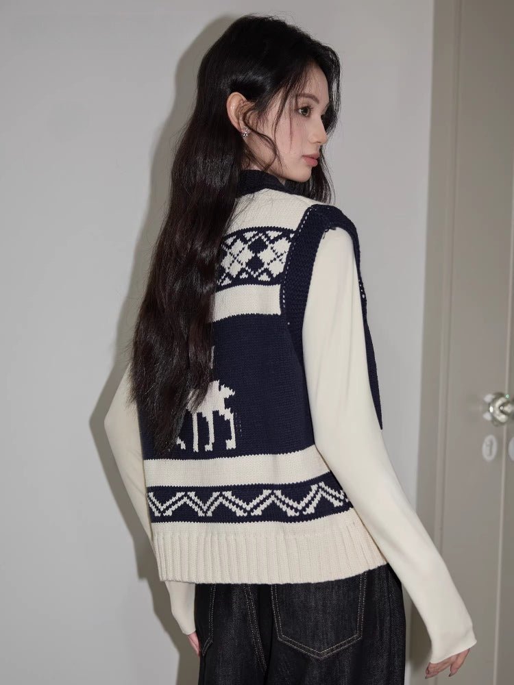Back view of a woman wearing a navy and cream knit zip-up vest with pattern