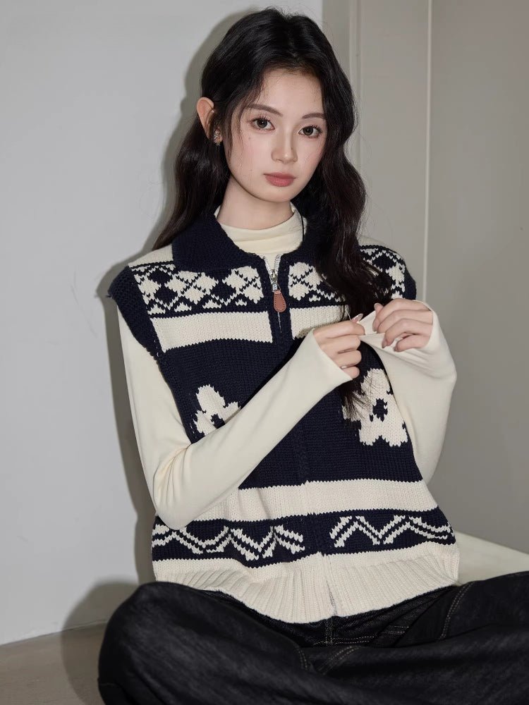 Close-up of a woman wearing a navy and cream knit zip-up vest
