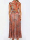 Back view of a woman in a sheer printed maxi dress