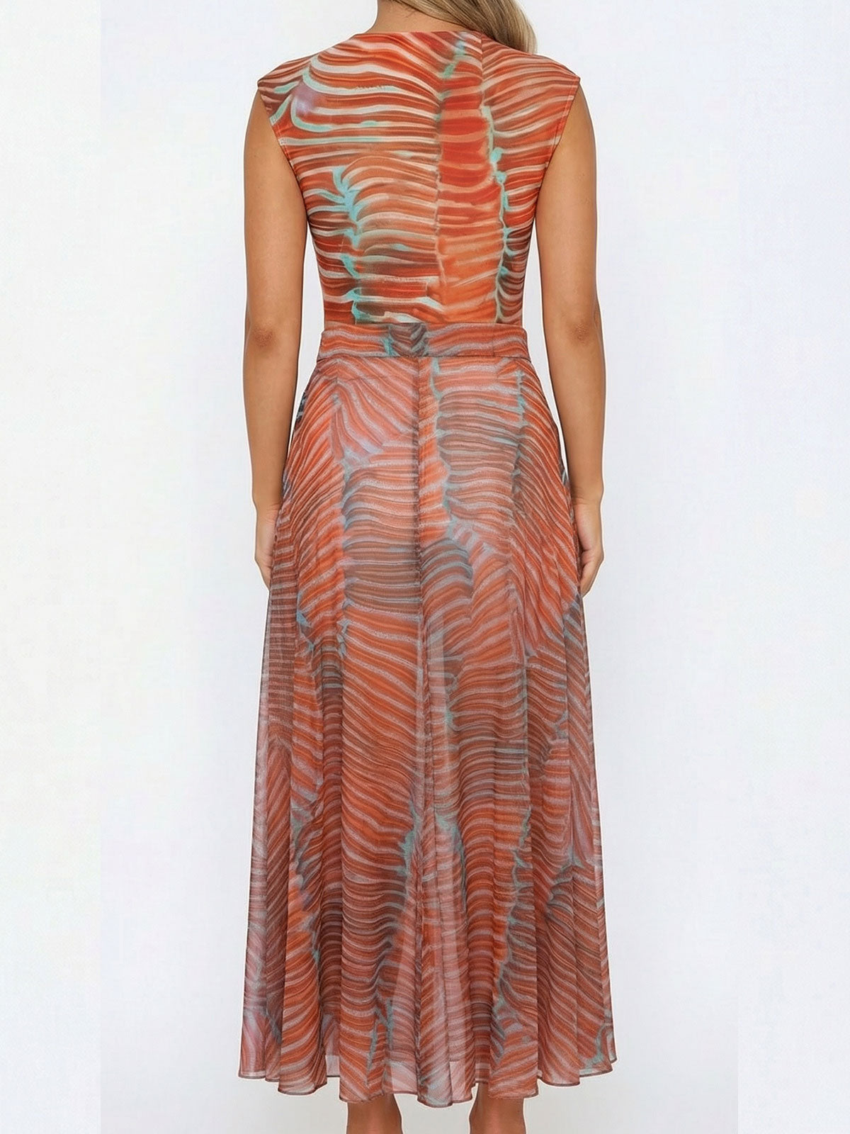 Back view of a woman in a sheer printed maxi dress