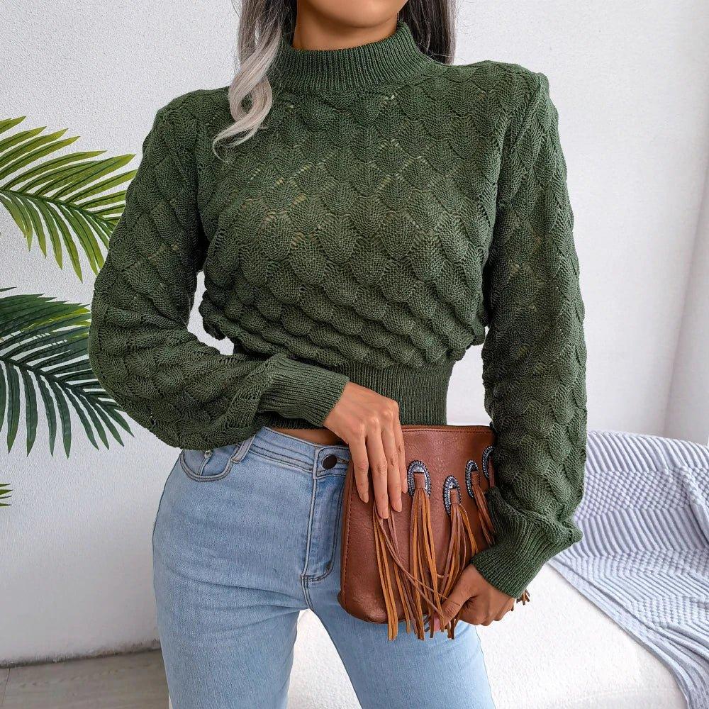 Woman wearing a green cropped mock neck sweater with textured diamond pattern and light wash jeans.