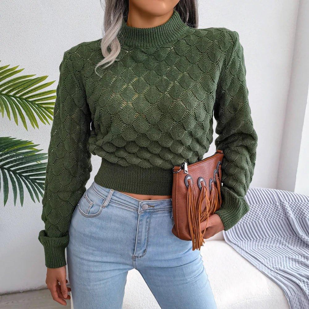 Woman wearing a green cropped knit sweater with a mock neck and textured pattern.