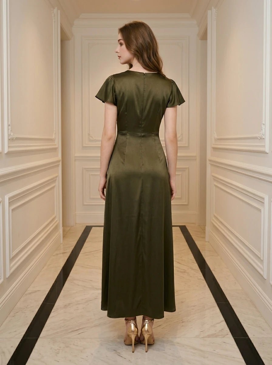 Woman wearing a long, olive green satin dress with a v-neck and button front