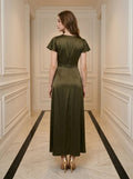 Back view of a woman in a long, olive green satin dress