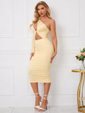 Front view of a woman wearing a fitted yellow one-shoulder dress with a twist-front bodice