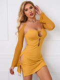 Close-up of a woman in a yellow bodycon dress with cutout details and long sheer sleeves.